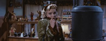 Movie still from “Bus Stop” (1956), directed by Joshua Logan – A woman wearing a fur coat and a fur hat; Medium shot, Over the shoulder angle