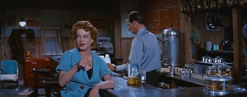 Movie still from “Bus Stop” (1956), directed by Joshua Logan – An older woman sitting at a counter with a man; Medium shot, Over the shoulder angle