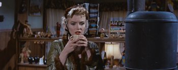 Movie still from “Bus Stop” (1956), directed by Joshua Logan – A woman holding a cup in her hands; Close Up shot, Over the shoulder angle