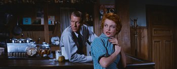 Movie still from “Bus Stop” (1956), directed by Joshua Logan – A man and a woman are sitting at a bar; Medium shot, Over the shoulder angle