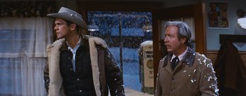 Movie still from “Bus Stop” (1956), directed by Joshua Logan – A man and a woman standing next to each other in the snow; Medium shot, Low angle