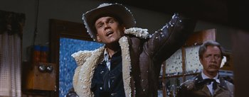 Movie still from “Bus Stop” (1956), directed by Joshua Logan – A man wearing a cowboy hat and a jacket; Medium shot, Low angle