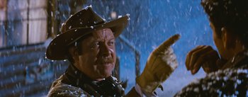 Movie still from “Bus Stop” (1956), directed by Joshua Logan – A man wearing a cowboy hat and gloves in the snow; Close Up shot, Low angle