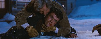 Movie still from “Bus Stop” (1956), directed by Joshua Logan – An older man and a younger man are laying in the snow; Close Up shot, Over the shoulder angle