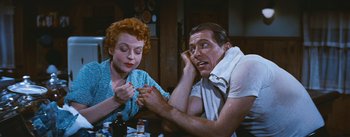 Movie still from “Bus Stop” (1956), directed by Joshua Logan – An older man and woman sitting at a dinner table; Medium shot, High angle