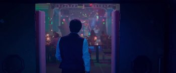 A man standing in front of a stage with lights in the background