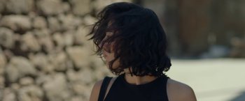 Movie still from “Butterflies” (2018), directed by Tolga Karaçelik – A person with a black shirt; Close Up shot, Over the shoulder angle