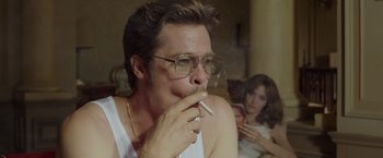 Movie still from “By the Sea” (2015), directed by Angelina Jolie – A man smoking a cigarette in front of a woman; Close Up shot, Over the shoulder angle