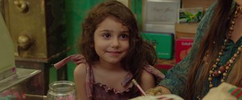 Movie still from “By the Sea” (2015), directed by Angelina Jolie – A little girl sitting in front of a table; Close Up shot, Over the shoulder angle