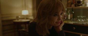 Movie still from “By the Sea” (2015), directed by Angelina Jolie – A person sitting in a chair; Close Up shot, Over the shoulder angle