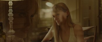 Movie still from “By the Sea” (2015), directed by Angelina Jolie – A woman with long blonde hair sitting in front of a mirror; Close Up shot, Over the shoulder angle