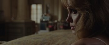 Movie still from “By the Sea” (2015), directed by Angelina Jolie – A woman's face as she sits on a bed; Close Up shot, Over the shoulder angle