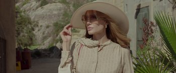 Movie still from “By the Sea” (2015), directed by Angelina Jolie – A woman wearing a hat and sunglasses outside; Close Up shot, Low angle