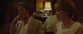 Movie still from “By the Sea” (2015), directed by Angelina Jolie – A man and a woman sitting next to each other in a room; Close Up shot, Over the shoulder angle