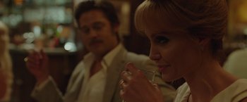 Movie still from “By the Sea” (2015), directed by Angelina Jolie – A man and a woman sitting next to each other; Close Up shot, Over the shoulder angle