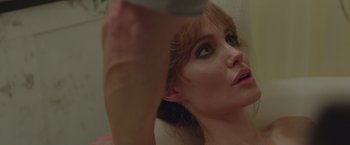 Movie still from “By the Sea” (2015), directed by Angelina Jolie – A woman's face as she looks at the camera; Close Up shot, Over the shoulder angle