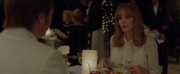 Movie still from “By the Sea” (2015), directed by Angelina Jolie – A woman sitting at a table with a candle in front of her; Close Up shot, Over the shoulder angle