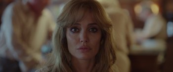 Movie still from “By the Sea” (2015), directed by Angelina Jolie – A person with long blonde hair; Close Up shot, Over the shoulder angle