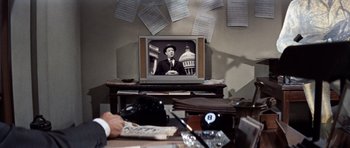 Movie still from “Bye Bye Birdie” (1963), directed by George Sidney – An old tv sitting on top of a wooden table; Medium shot, High angle