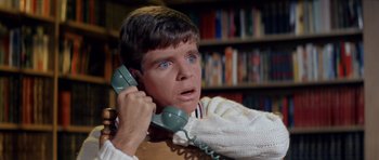 Movie still from “Bye Bye Birdie” (1963), directed by George Sidney – A man holding a phone up to his ear; Close Up shot, High angle