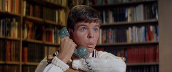 Movie still from “Bye Bye Birdie” (1963), directed by George Sidney – A man holding a phone up to his ear; Close Up shot, High angle