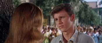 Movie still from “Bye Bye Birdie” (1963), directed by George Sidney – A man and a woman in front of a group of onlookers; Close Up shot, Over the shoulder angle