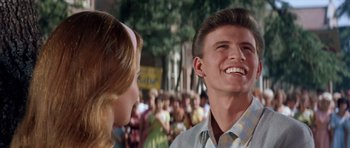 Movie still from “Bye Bye Birdie” (1963), directed by George Sidney – A man and a woman are smiling at each other; Close Up shot, Over the shoulder angle