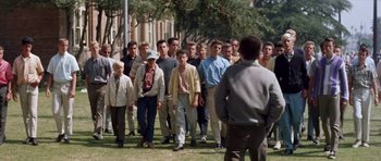 Movie still from “Bye Bye Birdie” (1963), directed by George Sidney – A group of men standing in the grass near a tree; Wide shot, High angle