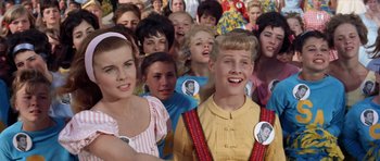 Movie still from “Bye Bye Birdie” (1963), directed by George Sidney – A bunch of people that are standing in a crowd; Medium shot, High angle