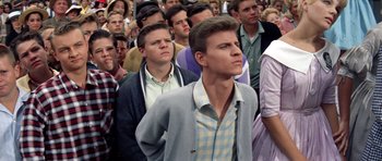 Movie still from “Bye Bye Birdie” (1963), directed by George Sidney – A group of people standing in front of each other; Medium shot, High angle
