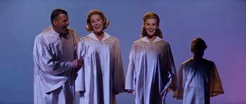 Movie still from “Bye Bye Birdie” (1963), directed by George Sidney – A couple of women standing next to each other on a stage; Medium shot, Low angle