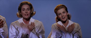 Movie still from “Bye Bye Birdie” (1963), directed by George Sidney – A couple of women standing next to each other; Medium shot, Low angle