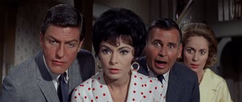Movie still from “Bye Bye Birdie” (1963), directed by George Sidney – A group of people standing next to each other in a room; Close Up shot, High angle