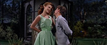 Movie still from “Bye Bye Birdie” (1963), directed by George Sidney – A man and a woman are standing next to each other; Medium shot, Low angle
