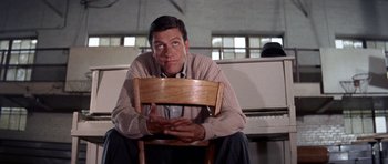 Movie still from “Bye Bye Birdie” (1963), directed by George Sidney – A man sitting on a chair in front of a piano; Medium shot, High angle