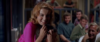 Movie still from “Bye Bye Birdie” (1963), directed by George Sidney – A woman holding onto a stuffed animal in front of a crowd; Close Up shot, Over the shoulder angle