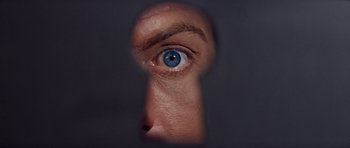Movie still from “Bye Bye Birdie” (1963), directed by George Sidney – A man with a blue eye looking through a keyhole; Extreme Close Up shot, Overhead angle