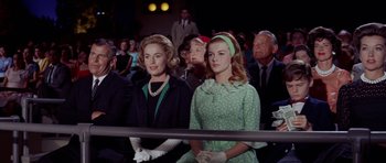 Movie still from “Bye Bye Birdie” (1963), directed by George Sidney – Two young women are sitting in the audience at an event; Medium shot, Low angle