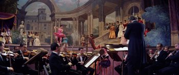 Movie still from “Bye Bye Birdie” (1963), directed by George Sidney – A group of people sitting in a room with musical instruments; Wide shot, Low angle