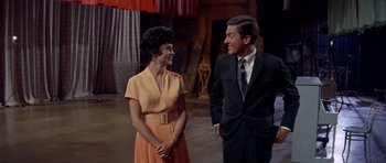 Movie still from “Bye Bye Birdie” (1963), directed by George Sidney – A man and a woman standing next to each other; Medium shot, Low angle