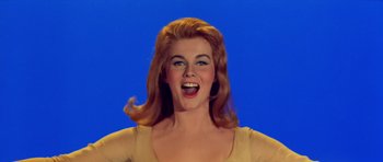 Movie still from “Bye Bye Birdie” (1963), directed by George Sidney – A woman with long red hair and a big smile; Close Up shot, Low angle