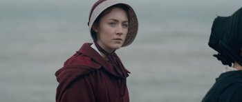 Movie still from “Byzantium” (2012), directed by Neil Jordan – A woman in a red coat wearing a white hat; Close Up shot, Over the shoulder angle