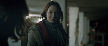 Movie still from “Byzantium” (2012), directed by Neil Jordan – A woman with long red hair wearing a sweater and a scarf; Close Up shot, Over the shoulder angle
