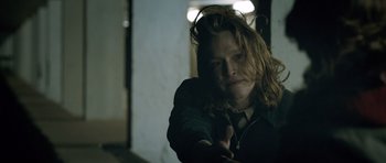 Movie still from “Byzantium” (2012), directed by Neil Jordan – A woman with long red hair is pointing a gun; Close Up shot, Low angle