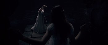 Movie still from “Byzantium” (2012), directed by Neil Jordan – Two women in white dresses are standing in a dark room; Wide shot, High angle