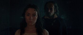 Movie still from “Byzantium” (2012), directed by Neil Jordan – A woman standing next to a man in a dark room; Close Up shot, Over the shoulder angle