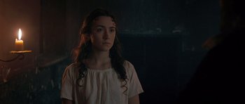 Movie still from “Byzantium” (2012), directed by Neil Jordan – A woman with long hair standing in a dark room; Close Up shot, Over the shoulder angle