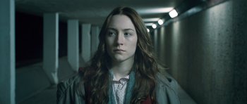 Movie still from “Byzantium” (2012), directed by Neil Jordan – A woman with long brown hair standing in a hallway; Close Up shot, High angle