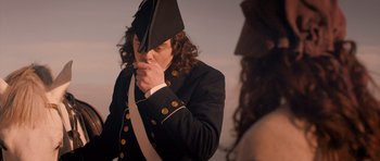 Movie still from “Byzantium” (2012), directed by Neil Jordan – A man in a military uniform is holding his hand up to his face; Medium shot, Over the shoulder angle