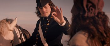 Movie still from “Byzantium” (2012), directed by Neil Jordan – A man in a black and white uniform is holding his hand up to his face; Close Up shot, Over the shoulder angle